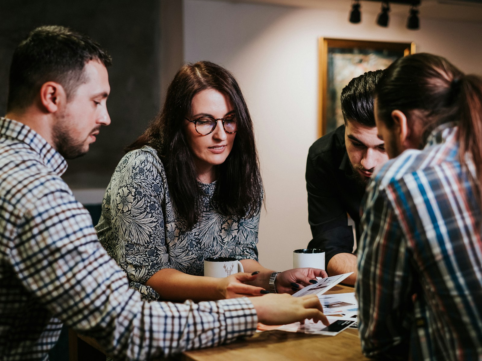 Four people reviewing documents together at a table