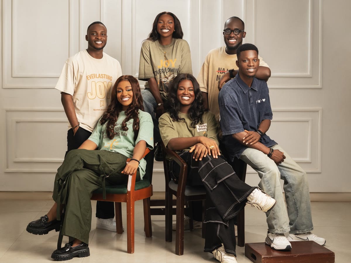 The six members of God in This Music, smiling together