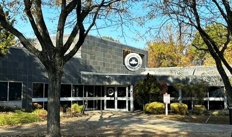 The Living Spring Linwood campus on an autumn day, with the RCCG emblem over the entrance